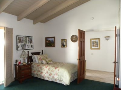 Cozy bedroom with floral bedding and wall decor
