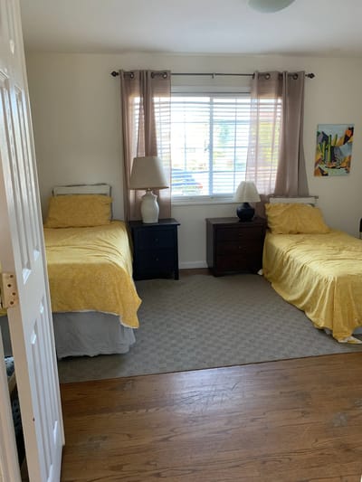 Cozy resident room with two beds and natural light