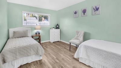 Brightly lit shared resident room with two beds