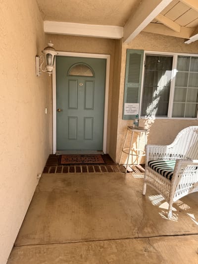 Front entrance of a residence with a green door