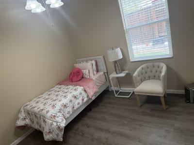Cozy resident room with bed and chair