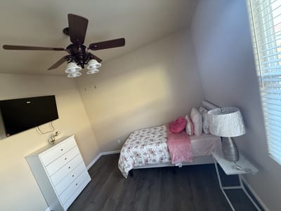 A cozy resident room with a bed and TV