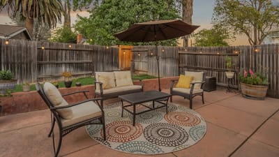 Outdoor seating area with cozy furniture and landscaping
