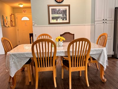 A dining room table set for residents in a care facility