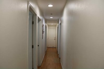 Simple hallway with lighted doors on both sides