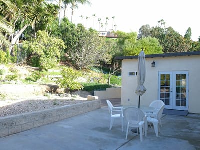 Outdoor patio area with seating and greenery