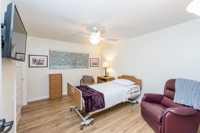 Cozy private resident room with bed and chair