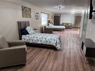 Interior view of a resident room with beds and seating