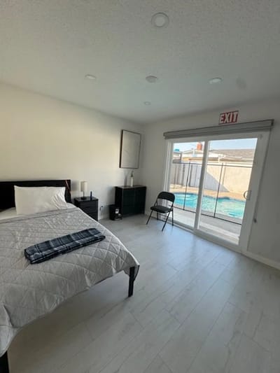 A private resident room with a bed and patio access