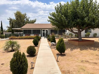 Exterior view of Krisnelle Home Care with gardens and pathway