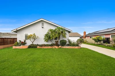 Exterior view of a home with lawn and garden
