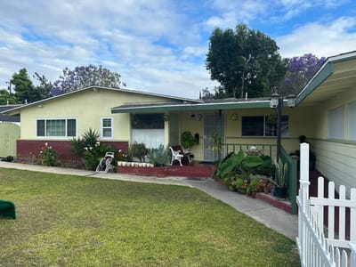 Exterior view of a residential care facility with lawn