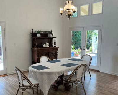 Bright dining area with white table and outdoor view