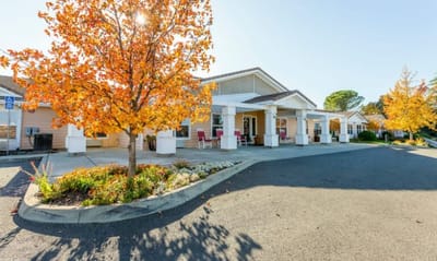 Welcoming exterior of Lassen House Senior Living with autumn colors