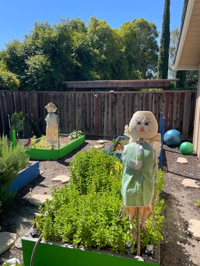 Garden area with decorative figures and greenery