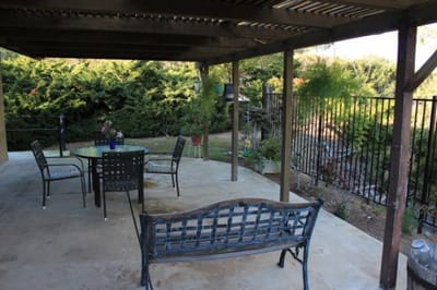 Outdoor patio area with seating and greenery