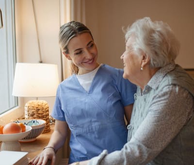 Staff member interacting with a resident in a cozy room