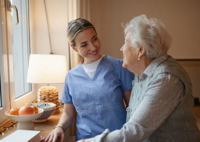 Caregiver interacting with a senior resident indoors