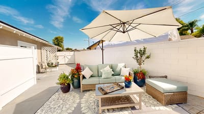 Outdoor seating area with plants and an umbrella