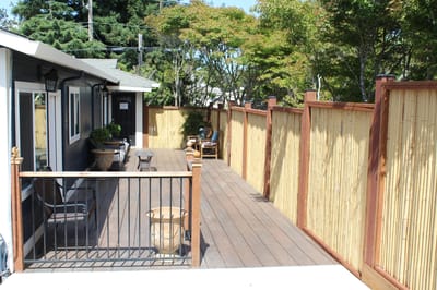Outdoor patio area with seating and privacy fence