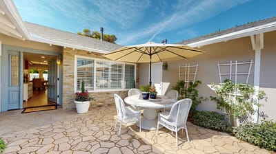 Outdoor patio area with table and umbrella