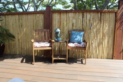 Outdoor seating area with wooden chairs and a table