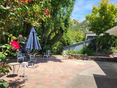 Outdoor seating area with colorful flowers and shrubbery