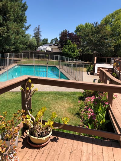 Outdoor pool area with seating and landscaping
