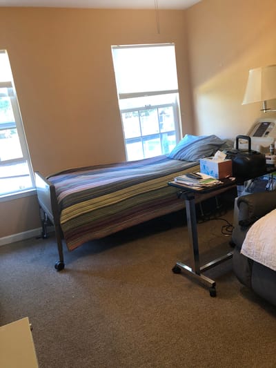 Cozy resident room with a bed and bedside table