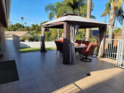 A covered outdoor seating area with patio furniture