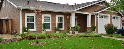 Exterior view of a senior living facility with garden.