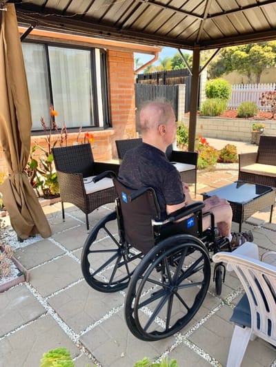 Resident in a wheelchair in a garden area