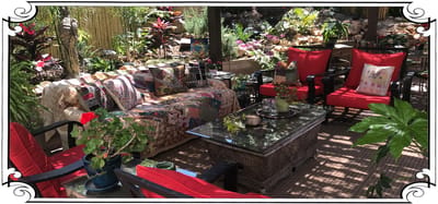 Outdoor seating area with vibrant plants and cushions