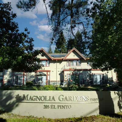 Exterior view of Magnolia Gardens facility with signage