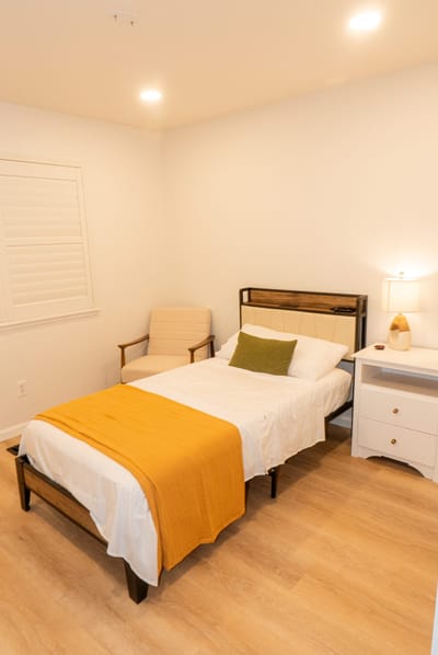 Cozy private room with a bed and chair