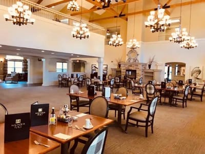 Dining area of Magnolia Place with tables and chandeliers