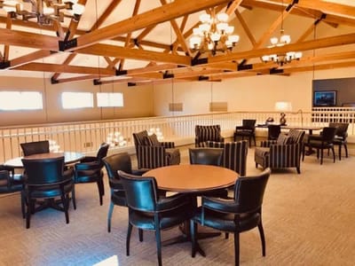 Bright common area with seating and chandeliers
