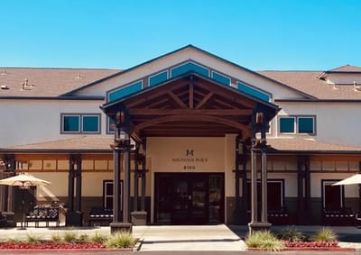 Entrance of Magnolia Place facility with outdoor seating