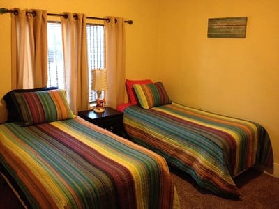 A cozy double bedroom with colorful bedding
