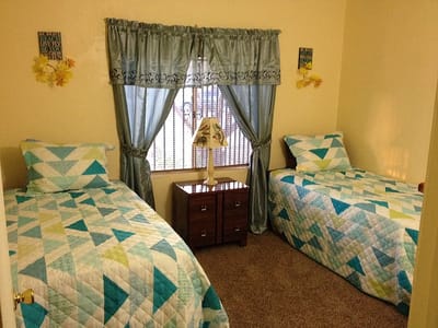 Cozy shared bedroom with two beds and soft lighting