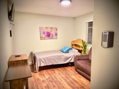 Cozy private resident room with a bed and seating area