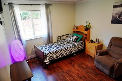 Cozy bedroom interior with a comfortable chair and window