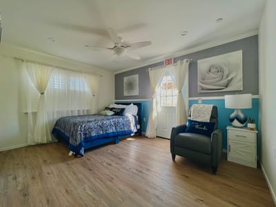 Cozy resident room with a bed and chair