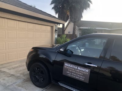 Vehicle with Maratha Manor signage parked outside