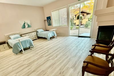 Cozy resident room with twin beds and garden view