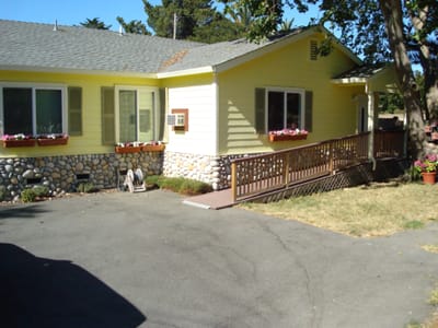 Exterior view of a senior living facility with garden area