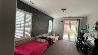 Bedroom with two beds and access to outdoor space