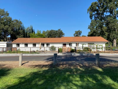 Exterior view of a senior living facility with garden