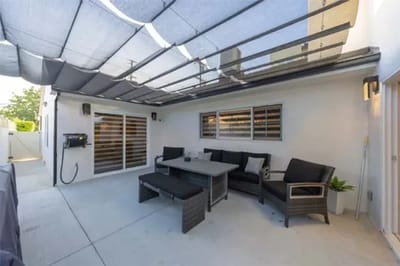 Covered outdoor seating area with modern furniture