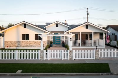 Exterior view of a nursing home with a white fence